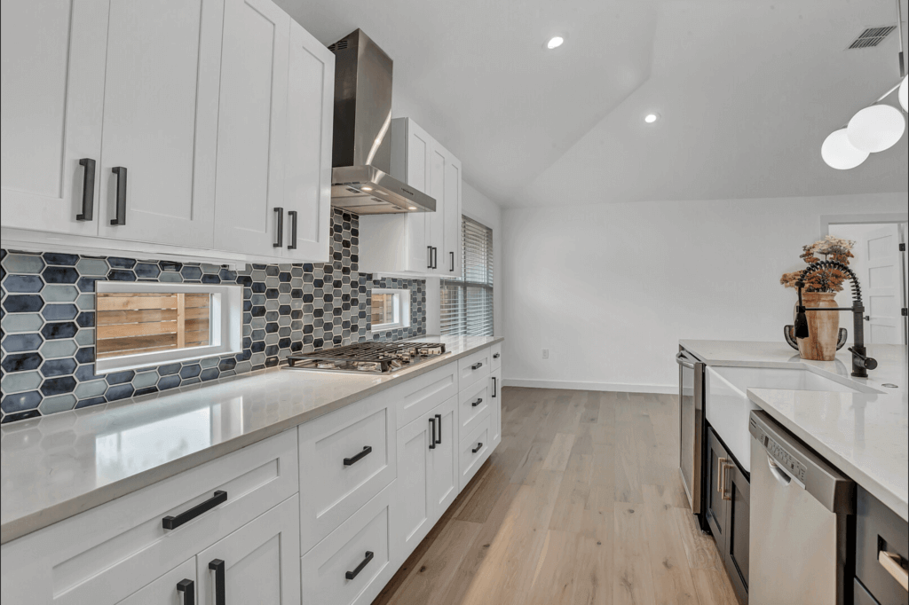 White cabinets and blue tile backsplash in kitchen in Allandale in Austin, Texas