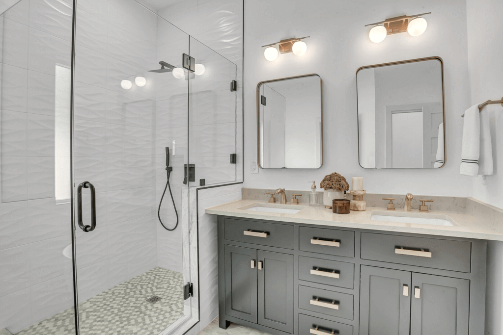 Bathroom in Allandale in Austin, Texas grey cabinets, gold mirrors