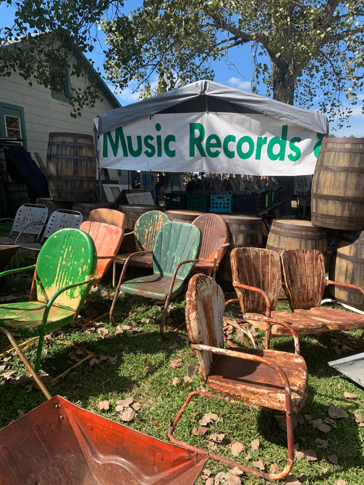 Field tent at Round Top Fall Antique Show with chairs and "Music Records" banner