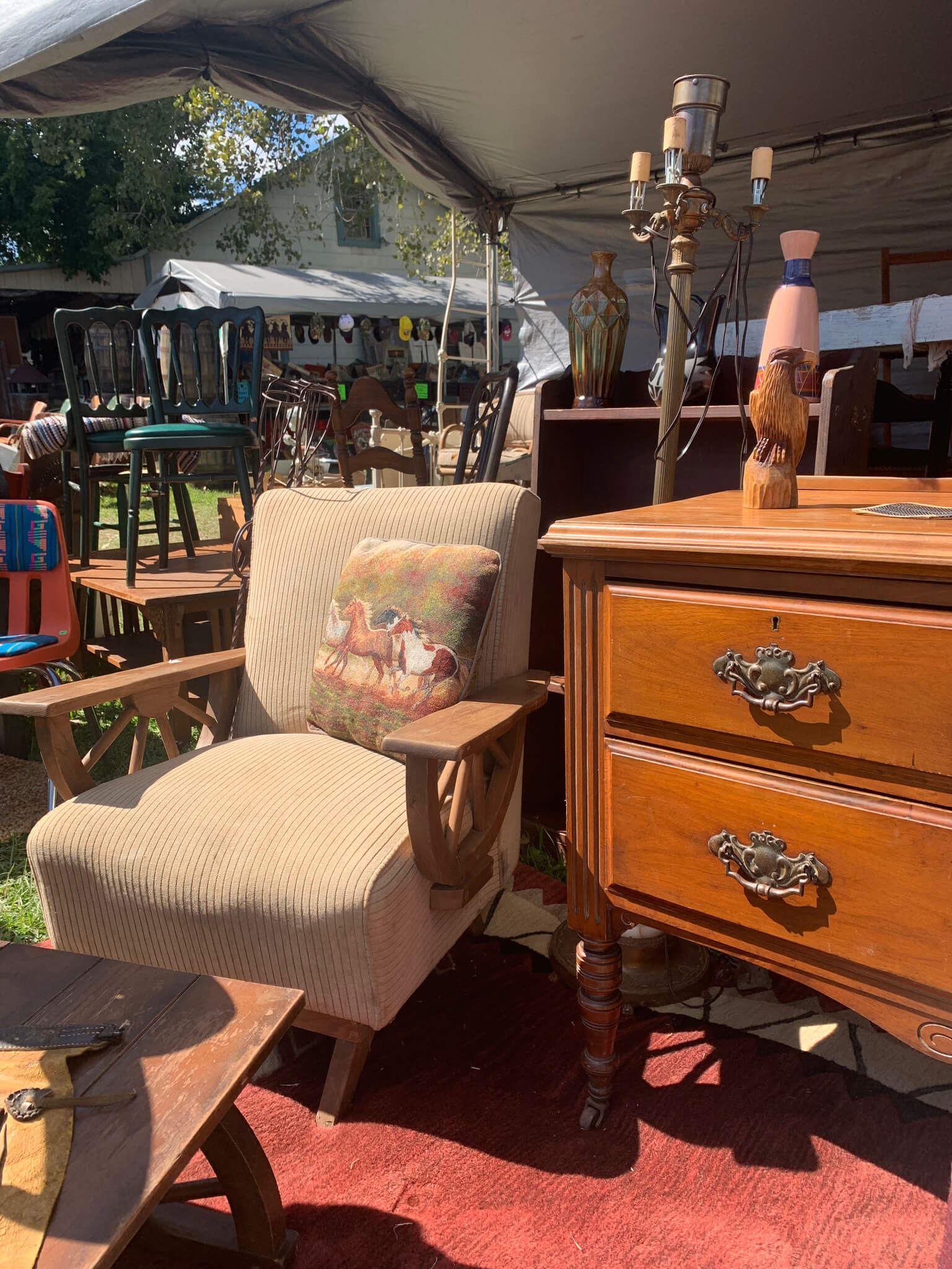 Tent at Round Top Fall Antique show with chair and dresser