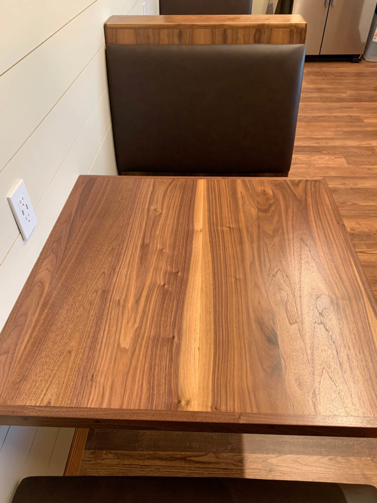 Custom booth wood table at University of Texas Women's Golf lounge in Austin, Texas