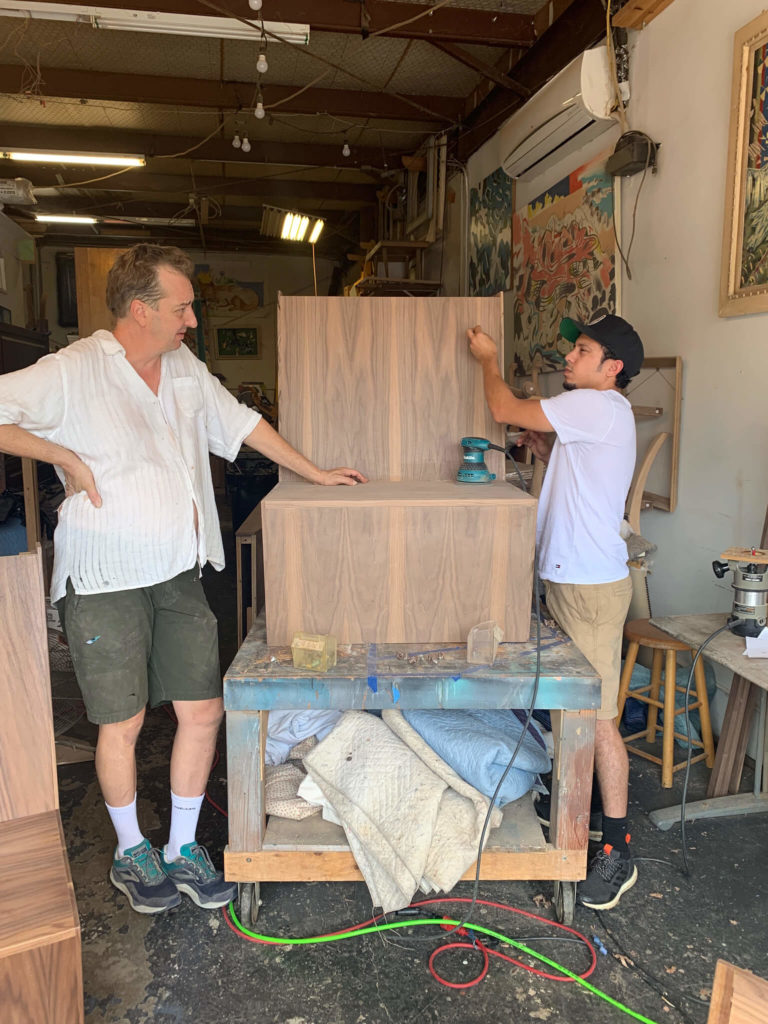 Carpenters working on custom wood booths for University of Texas Women's Golf lounge