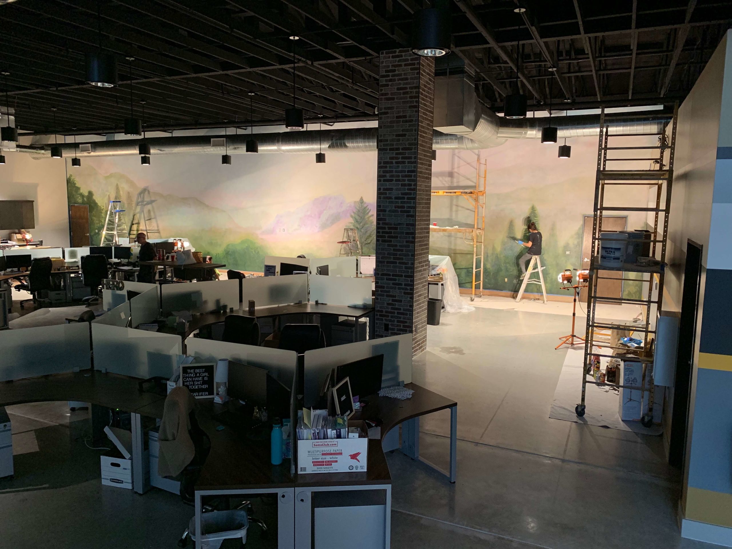 Mural of pastel mountains and trees inside open office space of DC Law Office in North Austin, Texas