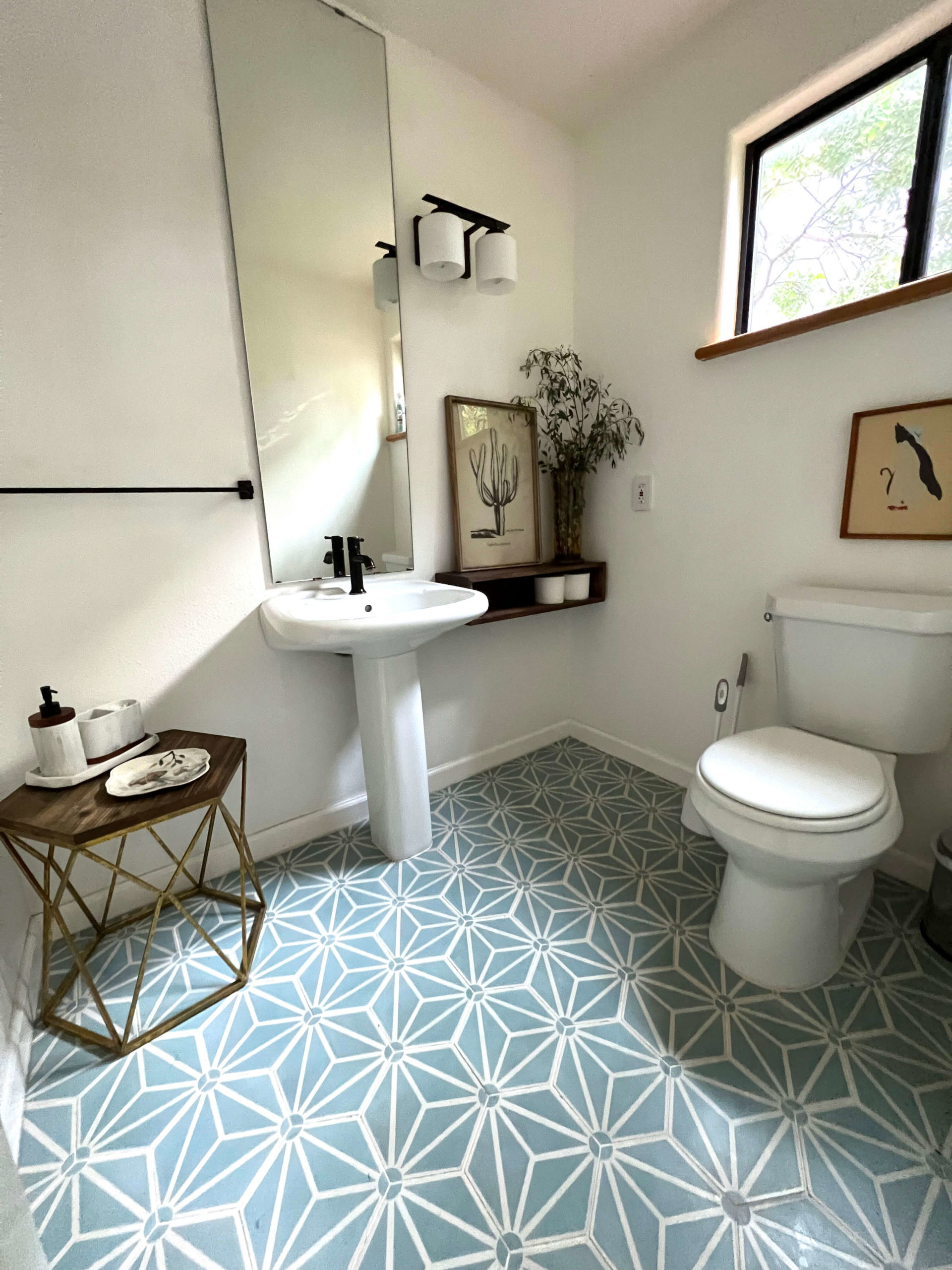 Bathroom in Bouldin Creek Airbnb in South Austin, Texas, blue geometric tile, geometric end table, vintage hanging art