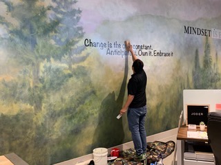 Quotes being painted on inspiration mural in DC Law office in North Austin