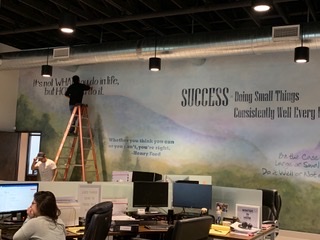 Quotes being painted on inspiration mural in DC Law office in North Austin